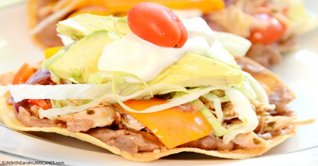 Looking for an easy and delicious family friendly meal? These slow cooker chicken tostadas are sure to be a hit and create a fun family meal for anytime. Slow Cooker Chicken Tostadas. SunshineandHurricnaes.com