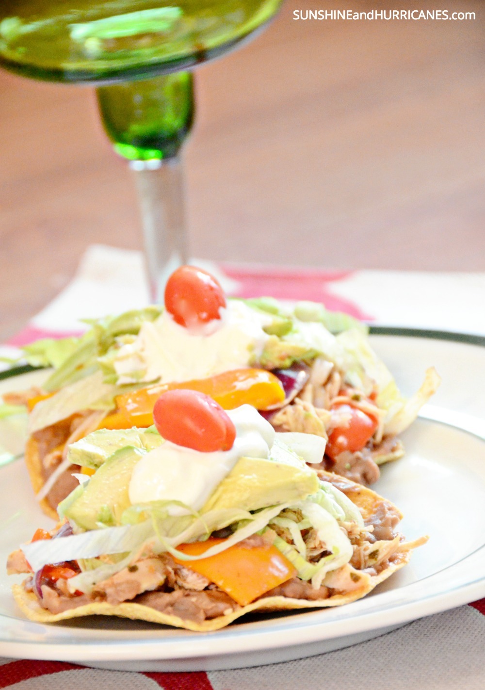 Looking for a super easy weeknight meal that the whole family will rave about? These slow cooker chicken tostados only require a few ingredients and come together for a quick meal  that will win over even the pickiest eaters. Slow Cooker Chicken Tostados. SunshineandHurricanes.com