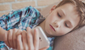 Picture of tween or young teen scrolling on cell phone