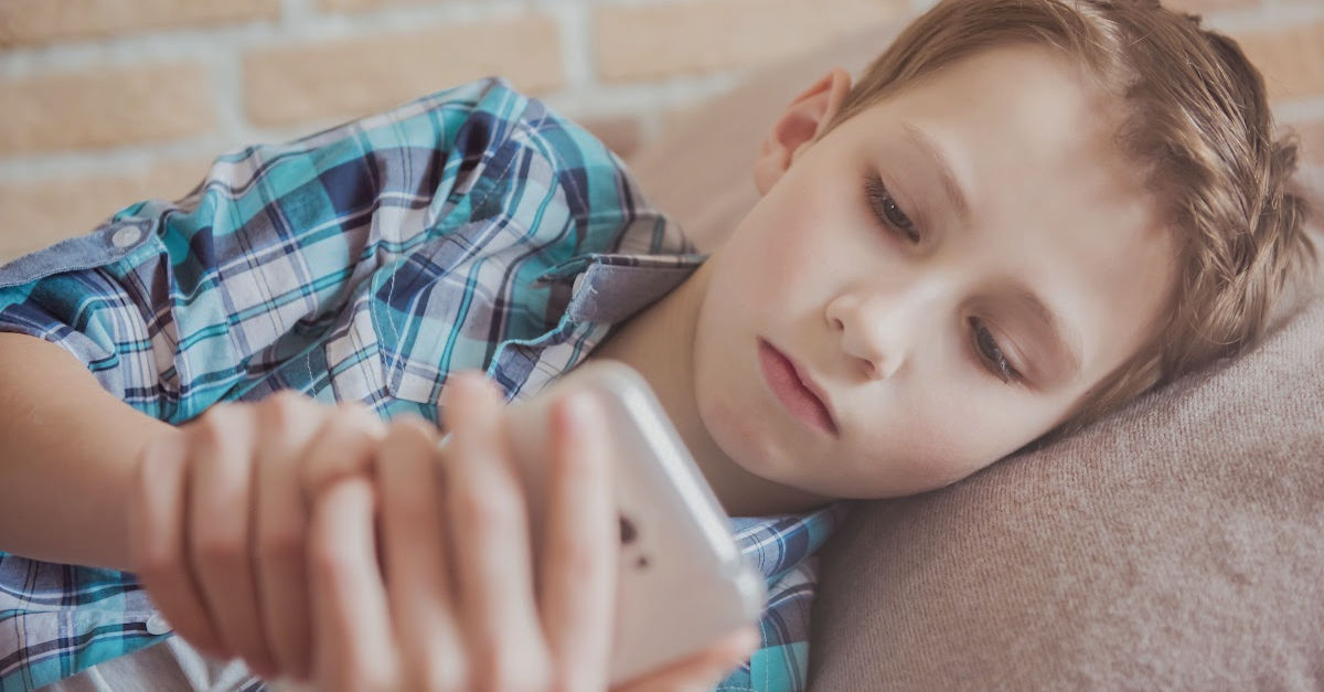 Picture of tween or young teen scrolling on cell phone